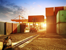 When the container terminal at dusk, work cranes and forklift.